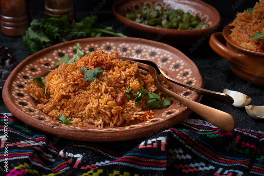 Mexican rice served in traditional clay pot and plate Stock Photo ...