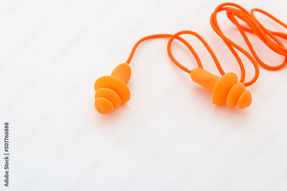 Fototapeta premium Orange earplugs on the White Background