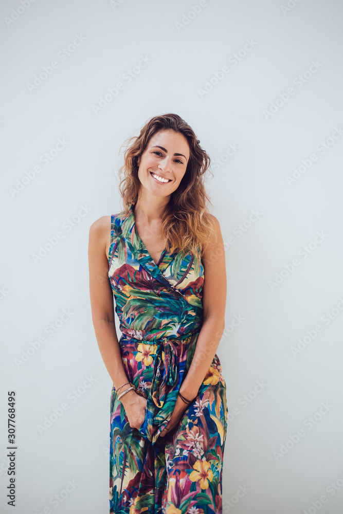 Attractive woman tilting head and leaning on wall Attractive woman tilting head and leaning on wall