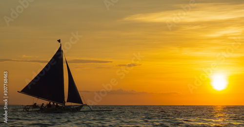 sailing boat at sunset. orange sky. boat on a sunset background. sailboat on a sunset background. beautiful sunset. unusual sky