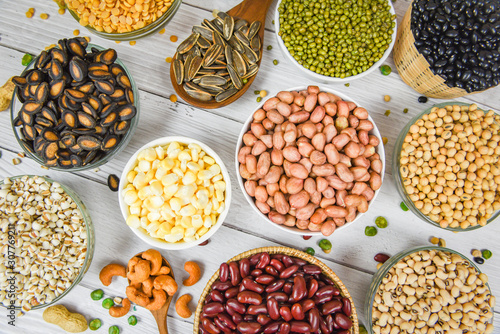 Different whole grains beans on bowl and legumes seeds lentils and nuts colorful snack background top view - Collage various beans mix peas agriculture of natural healthy food for cooking ingredients