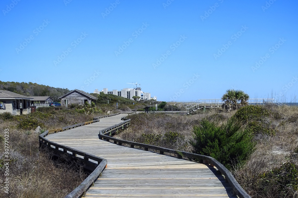Boardwalk winds its way through the dunes to the beach and ocean beyond