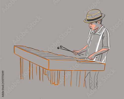 Yooung man playing the traditional marimba