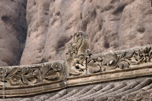 Architectural details of the roof at Tianshui Wushan Water Curtain Caves, Gansu China. OR Temple roof details at the Water Curtain Caves in Wushan , Gansu, China. photo