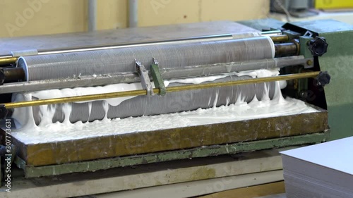 Paper gluing machine in the factory