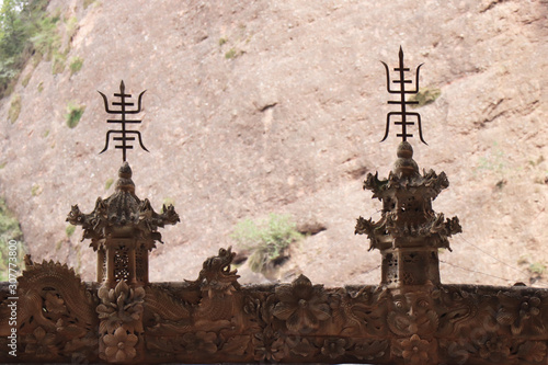 Architectural details of the roof at Tianshui Wushan Water Curtain Caves, Gansu China. OR Temple roof details at the Water Curtain Caves in Wushan , Gansu, China. photo