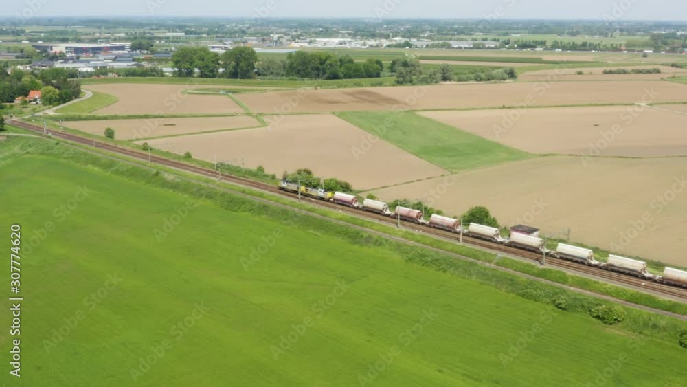 Drone shot of a industrial train passing by in Holland Drone shot of a industrial train passing by in Holland