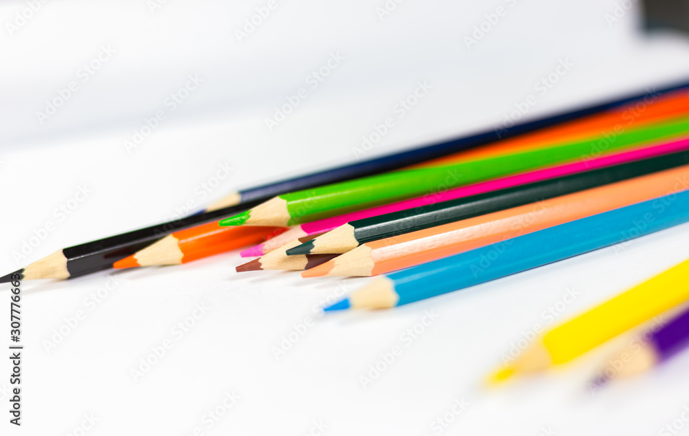 The crayon is on the white paper. The crayon is on the white paper.