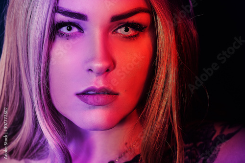 Gorgeous blonde in neon color, red-blue color, abstract background. Girl with white lenses. Portrait is gorgeous © MoreThanProd