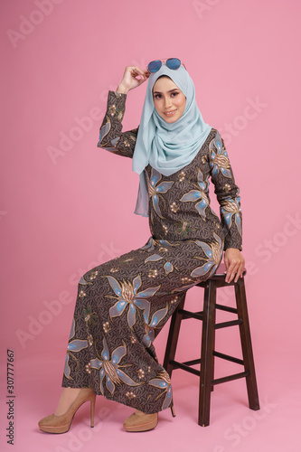 Beautiful Female Model Wearing Batik Design Baju Kurung With Light Green Hijab Sitting In Various Poses Isolated Over Pink Background Eidul Fitri Fashion And Beauty Concept Stock Photo Adobe Stock