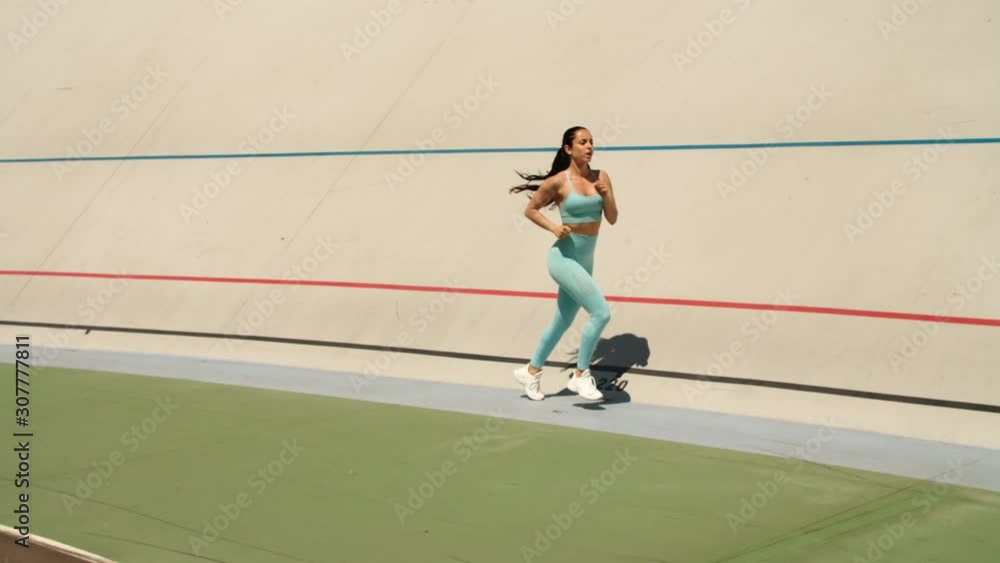 Sexy woman training on athletics track at stadium. Athlete woman sprinting Sexy woman training on athletics track at stadium. Athlete woman sprinting