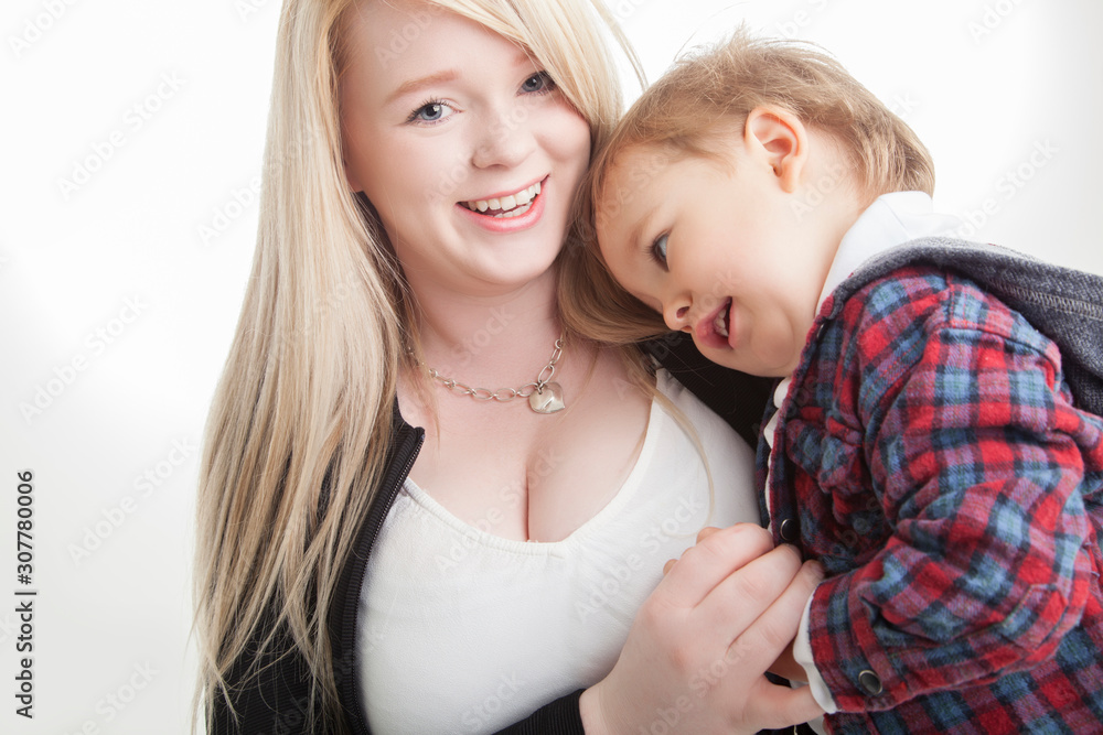 Young mother cuddling toddler boy on white background Young mother cuddling toddler boy on white background