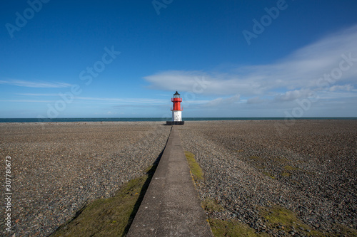 Lighthouse on pebble beach, Point of Ayre, Isle of Man, British Isles