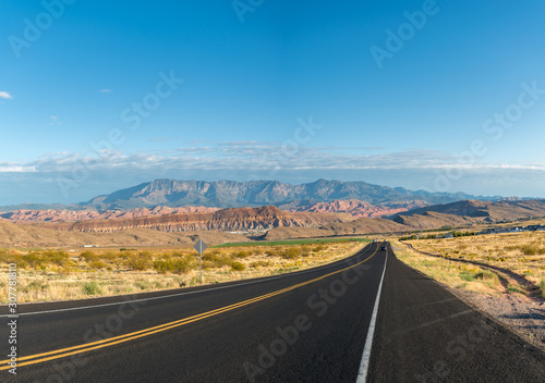 Loe angle View of Two Way Highway Into the Distance with Mountains in the Background