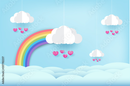 Rainbow and clouds in the blue sky, and pink heart