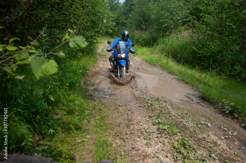Travelling on an enduro motorcycle in the taiga.