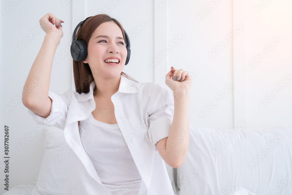 happiness asian woman white dress costume enjoy dance listening music with headphone bedroom background happiness asian woman white dress costume enjoy dance listening music with headphone bedroom background
