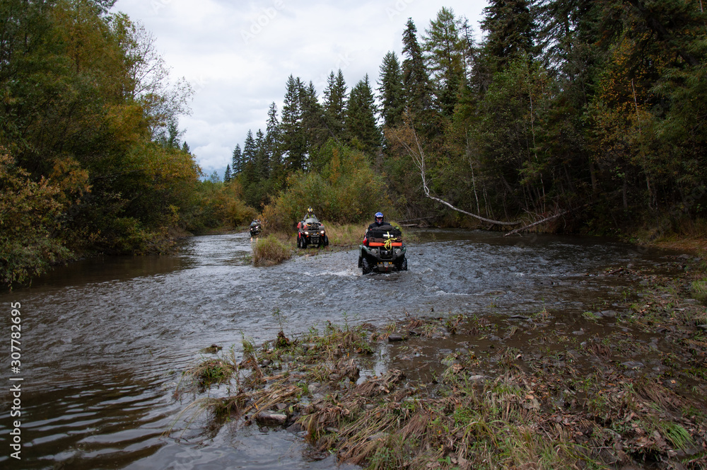 Fototapeta premium ATV in the expedition overcomes the water barrier