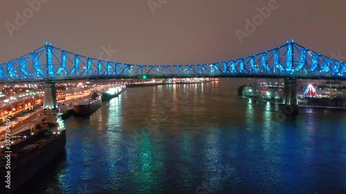 drone flying towars jacques cartier bridgein ontreal at night photo