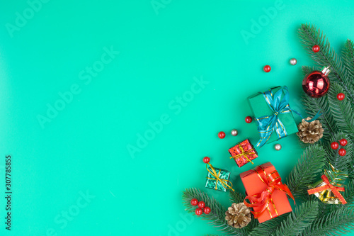 Christmas holidays composition, top view of red Christmas decorations on green background with copy space for text. Flat lay, winter, postcard template, new year concept.