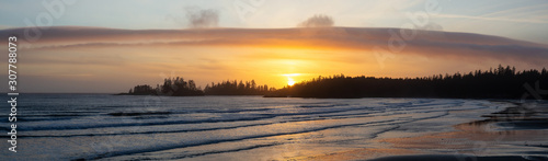 Long Beach, Near Tofino and Ucluelet in Vancouver Island, BC, Canada. Beautiful panoramic view of a sandy beach on the Pacific Ocean Coast during a vibrant sunset.