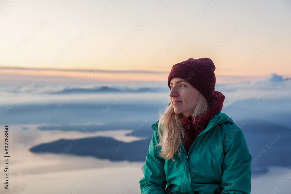 Adventurous Blond Caucasian Girl sitting on top of a snow covered mountain during a colorful winter sunset. Taken on St Mark's Summit, North of Vancouver, BC, Canada. Adventurous Blond Caucasian Girl sitting on top of a snow covered mountain during a colorful winter sunset. Taken on St Mark's Summit, North of Vancouver, BC, Canada.