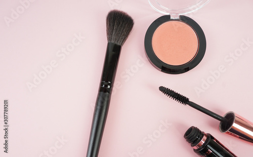 A few make up tools on pink table. Flat lay. Selective focus