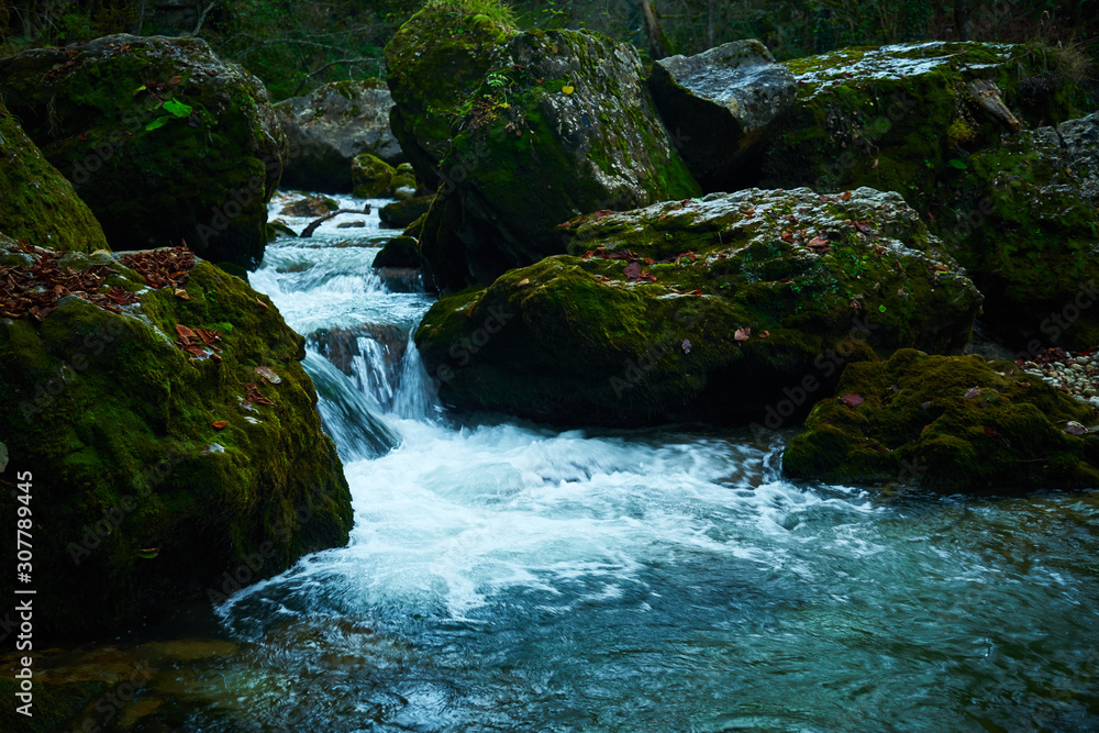 Clean mountain river in the autumn forest..Waterfall on a mountain river. Clean mountain river in the autumn forest..Waterfall on a mountain river.