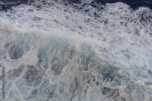 Abstract blue sea water with white foam for background, nature background concept