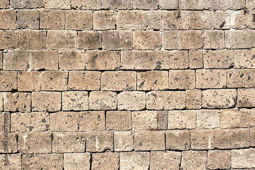 Background from a beige natural stone wall