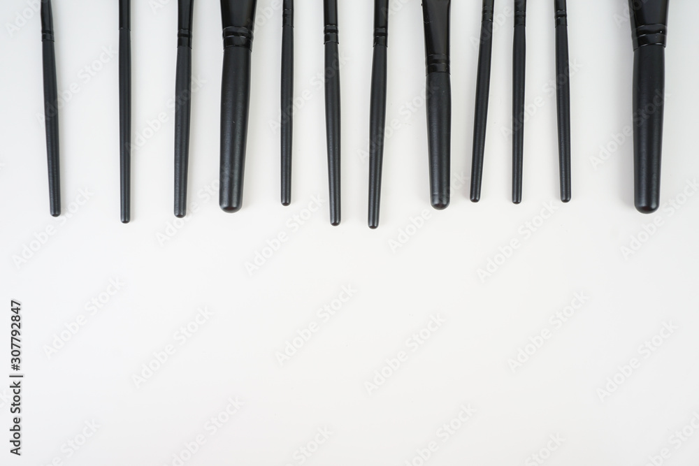 A set of a black make up brushes over the white background A set of a black make up brushes over the white background