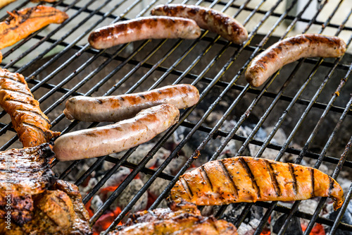 Barbecue grill bbq on coal charcoal grill with steaks bratwurst sausages and meat delicious summer meal