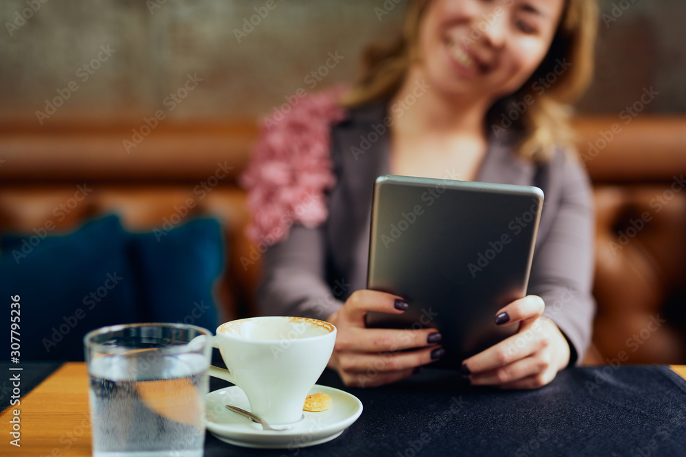 Beautiful Asian woman with tablet in her hands smiling Beautiful Asian woman with tablet in her hands smiling