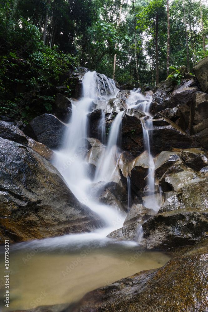 Obraz premium Beautiful waterfall view in the jungle. Long exposure image of water