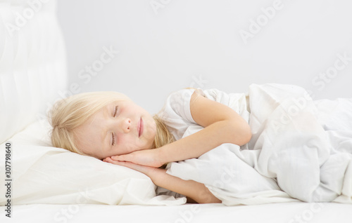 little cute girl sleeping in her bed