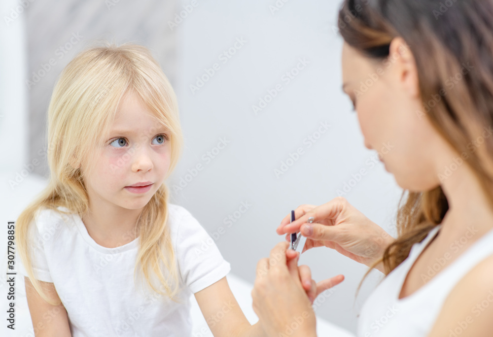 Mother clipping her fingernails to child Mother clipping her fingernails to child