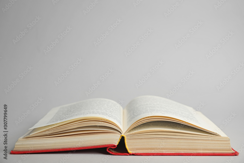 Open old hardcover book on light grey background. Space for text Open old hardcover book on light grey background. Space for text