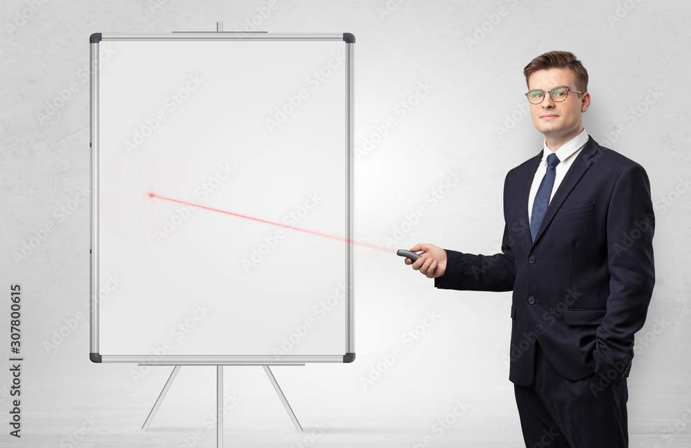 Young businessman with laser pointer and copyspace white blackboard Young businessman with laser pointer and copyspace white blackboard