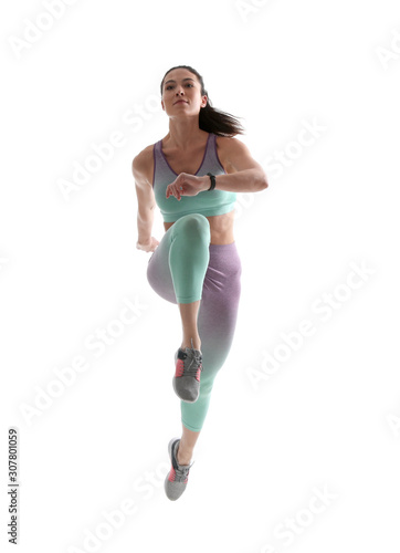 Athletic young woman running on white background photo