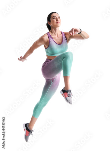 Athletic young woman running on white background