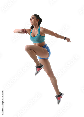 Athletic young woman running on white background