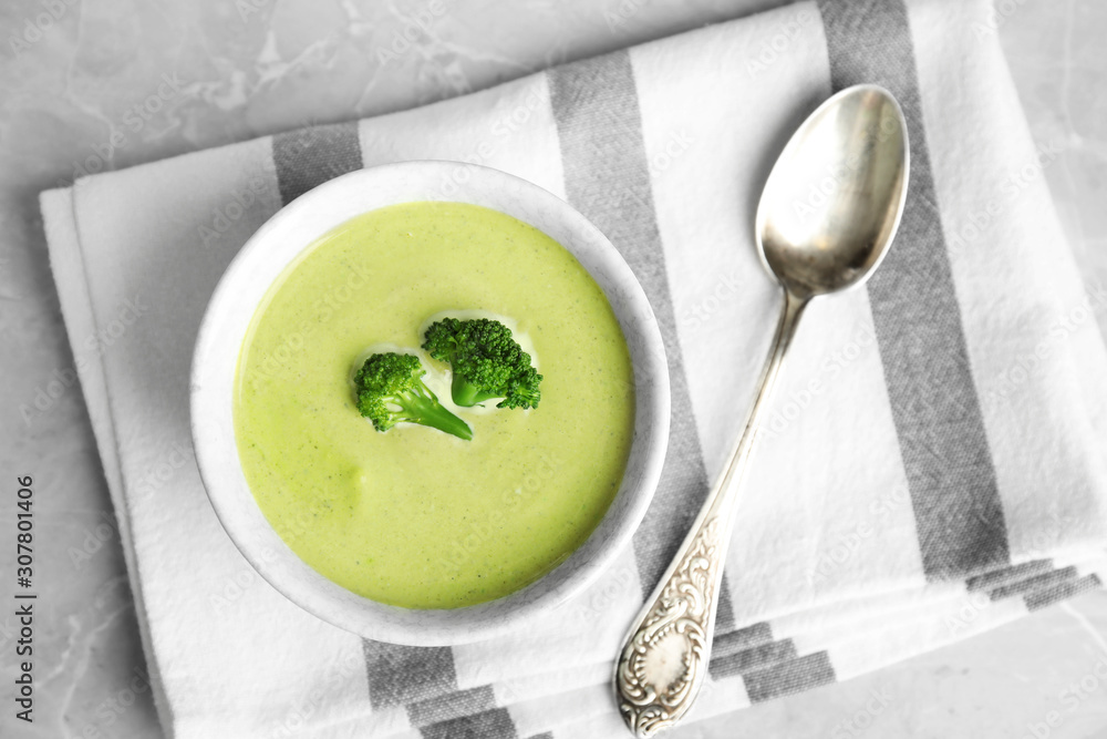 Delicious broccoli cream soup served on grey marble table, top view Delicious broccoli cream soup served on grey marble table, top view