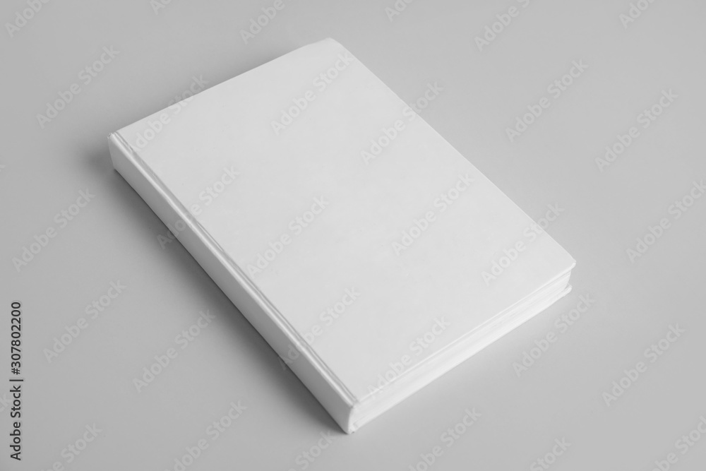Book with blank cover on grey background Book with blank cover on grey background
