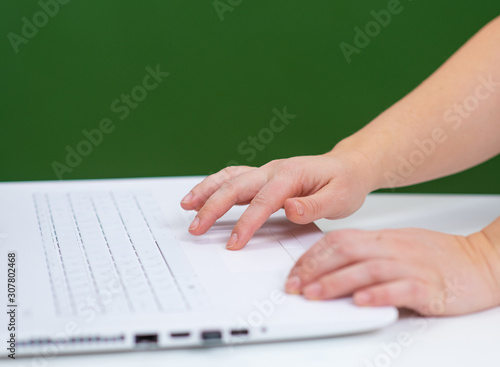 hand on blackboard background I type on the laptop