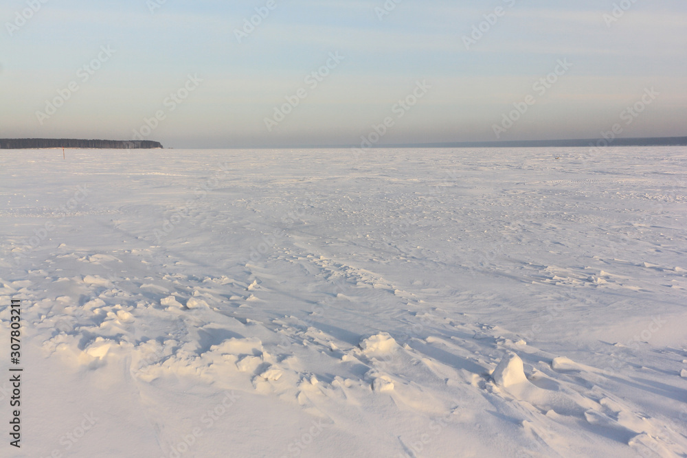 Snow on the frozen river in the winter, Ob reservoir, Novosibirsk, Russia Snow on the frozen river in the winter, Ob reservoir, Novosibirsk, Russia