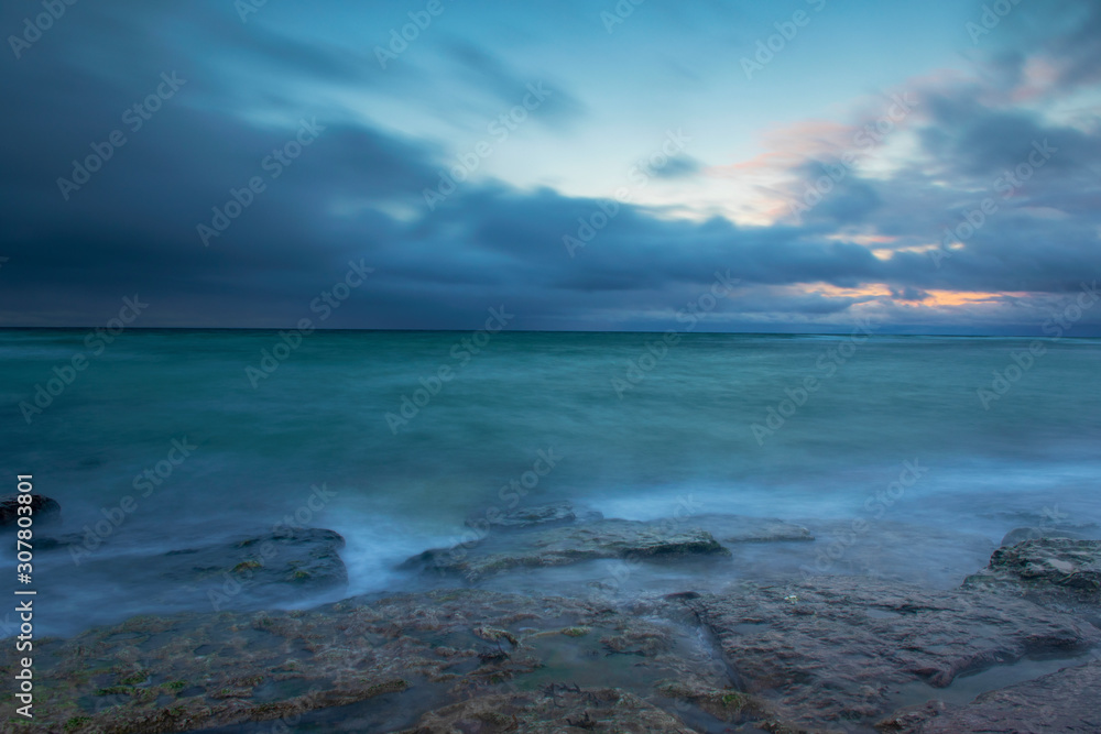 Fototapeta premium Snow Clouds Over Ocean, Winter Sunset