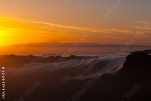 Sceninc overview over Gran Canaria facing Tenerife with the Teide from the mountain peak Pico de las Nieves during sunset © Robert Ruidl