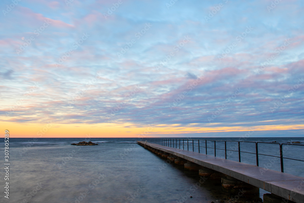 Bath Pier With An Cloudy Sunrise At Norderstrand Beach on Island of Gotland in Sweden