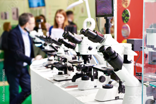 People and microscopes in store photo