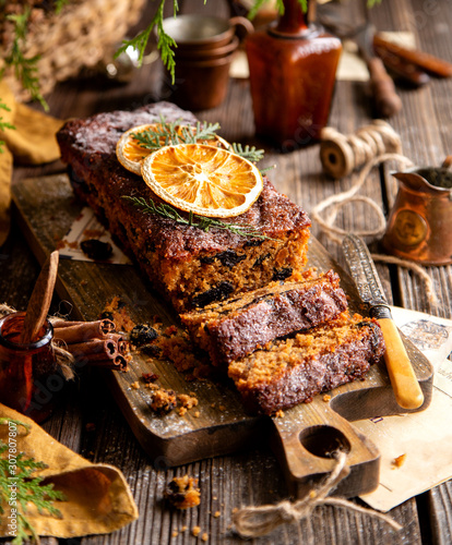homemade traditional christmas fruit cake cut on slices with fruits, nuts, dried citrus